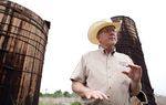 Landowner Stuart Carter, in Central Texas near the town of Luling, has years of abandoned oil equipment on his property. Here, two oil wooden oil tanks that he says date to the 1920s.