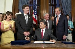 Gov. Rick Perry smiles after signing HB 5 the education reform bill before a crowd in the Governor's Reception Room on June 10, 2013. Left to right are Sens. Donna Campbell, R-New Braunfels, Dan Patrick, R-Houston, Rep. Jimmie Don Aycock, R-Killeen and Lt. Gov. David Dewhurst.