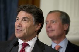Governor Rick Perry and Lt. Gov. David Dewhurst answer questions from the media after a series of education bill signings on June 10, 2013.