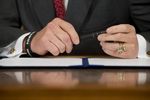Gov. Rick Perry prepares to sign a series of education reform bills in the Governor's Reception Room on June 10, 2013.