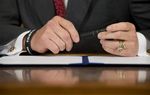 Gov. Rick Perry prepares to sign a series of education reform bills in the Governor's Reception Room on June 10, 2013.