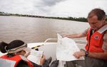 Professor Kirk Winemiller and Graduate student Rebecca Pizano, both from the Texas A&M Department of Wildlife and Fisheries, look at maps near the salt water damn on the Neches River near Beaumont, Texas Friday, May 30, 2013.