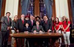 Gov. Rick Perry signs House Bill 308 which allows public school students and staff to use traditional holiday greetings and display religious symbols on school property. He was joined by bill author Rep. Dwayne Bohac R-Houston, Bahac's  son Reagan, Sen. Robert Nichols as well as several Santa's, Rabbi Zev Johnson and cheerleaders from Kountze High School - June 13, 2013.