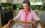 Nadene Lokey with a photo of her brother, WWII hero Audie Murphy, at her home in Farmersville, Texas on June 17, 2013.