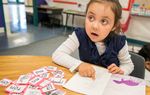 An early reader looks to teacher, Josefina Pineda, in her Pre-K at the Dallas Independent School District elementary school Cesar Chavez Learning Center in Dallas, Texas.