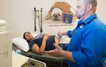 Dr. Brad Faglie, one of the family physicians being denied hospital privileges at the nearby Wise Regional Health System, examines Adriana Zuniga, a pregnant Medicaid patient at a medical clinic in Alvord.
