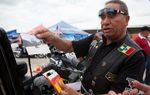 Jorge Rojas Lopez of the Dorados De Villa motorcycle club displays photographs of his fellow riders at the Republic of Texas Biker Rally in Austin, Texas June 14th, 2013.