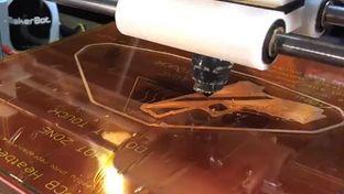 A non-functioning 3d gun being printed in a residential basement.