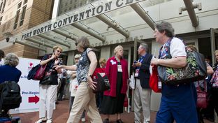 Texas Republican Convention delegates congregate outside the Fort Worth Convention Center on June 7, 2012.