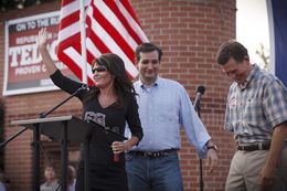 Republican primary candidate Ted Cruz, center, is joined on stage by Sarah Palin, left, and Senator Jim DeMint, right, at a rally in The Woodlands, Texas, on Friday July 27, 2012.