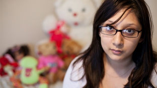 Crystal Martinez sits with items recovered from Child Protective Services at her home in North Austin, Dec. 21, 2010.