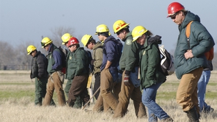 Members of the Los Padres and INYO C-25 firefighting teams from Oregon and California walk shoulder-to-shoulder through fields outside this north Texas town as the search for Columbia space shuttle debris  Photo 