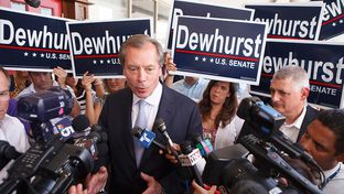 Lt. Gov. David Dewhurst talking with reporters while campaigning for U.S. Senate in Houston on July 31, 2012.