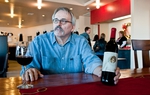 Gary McKibben, owner of the Red Caboose Winery in Clifton, uses paintings by local artists like Robert Fobear to distinguish his wine labels.