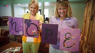 Executive Director Kellie Armstrong, right, and founder Nikki Richnow, left, showing some of paintings that the resident girls made while at Freedom Place near Houston Monday, July 2, 2012.