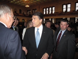 Perry shakes hands after a speech in the Texas House.