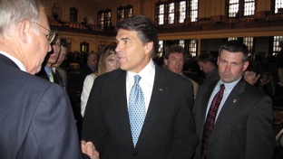 Perry shakes hands after a speech in the Texas House.