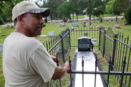 Reverend Rodney Norsworthy, a minister at Mount Olive Missionary Baptist Church, shows the grave of James Byrd, at a cemetery in Jasper, TX on June 15 2012.