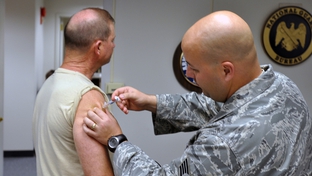 A National Guard soldier receives a seasonal flu shot in Virginia in 2009. 