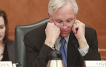 Senate Finance Chairman Steve Ogden (R-Bryan) looks grim while he peruses Senate Bill 1 on January 31, 2011.