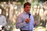 Gov. Rick Perry, speaks at the site in Jonestown, Texas, where volunteers will build a home for injured war veteran Augustine "Augie" Pena.