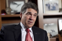 Gov. Rick Perry speaks with a reporter on Feb. 21, 2012, a month after dropping his bid for the Republican presidential nomination.