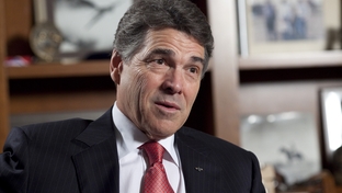 Gov. Rick Perry speaks with a reporter on Feb. 21, 2012, a month after dropping his bid for the Republican presidential nomination.