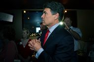Gov. Rick Perry on May 29, 2012, watching television returns after speaking at the party for Charles Schwertner's victory in the Texas Senate race for District 5.