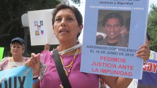 A member of the Caravan for Peace with Justice and Dignity marches on the state Capitol Saturday, August 25, 2012.