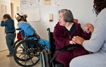 Resident Bea Garza ("B.B.") is assisted by Trina Howard, an employee at the Austin state school.