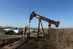 Local pumper Bobby Thomason works on cleaning up an old well that was recently worked over to start producing again on a lease in Caldwell County near Luling, January 22, 2012.