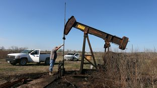 Local pumper Bobby Thomason works on cleaning up an old well that was recently worked over to start producing again on a lease in Caldwell County near Luling, January 22, 2012.