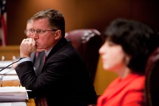 The Texas Railroad Commission, comprised of Chairman Barry T. Smitherman (center), and commissioners David Porter (left) and Christi Craddick (right) hold an open meeting in Austin, Texas on Jan. 15, 2013.