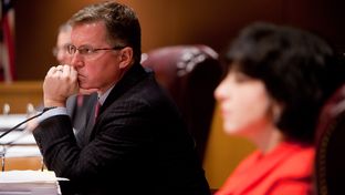 The Texas Railroad Commission, comprised of Chairman Barry T. Smitherman (center), and commissioners David Porter (left) and Christi Craddick (right) hold an open meeting in Austin, Texas on Jan. 15, 2013.