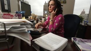 Genevieve Davis, director of payment advocacy for the Texas Medical Association working the computer and her phone at her desk in Austin, Texas February 20, 2012.
