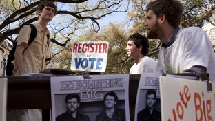 John Lawler, a candidate for student body president at the University of Texas, talks with a student on the West Mall.