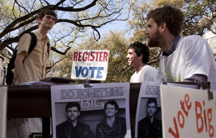 John Lawler, a candidate for student body president at the University of Texas, talks with a student on the West Mall.