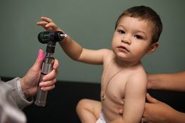 Helen Hawkins, a certified pediatric nurse practitioner, treats 13-month-old Kevin Gorostieta at Carousel Pediatrics in Austin on Nov. 8, 2012.