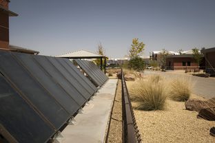A solar field provides power for a water heating system and xeriscaping on a Fort Bliss Army installation.