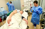 Endoscopy tech Dora Facturan, right, prepares Maria Perez, 65, for a colonoscopy exam from Dr. Carlos Cardenas, back left, on December 8, 2010 at the Doctor's Hospital at Renaissance in Edinburg. South Texans lead some of the longest lives in the state. 