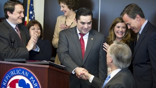 State Representative J.M. Lozano (center) shakes hands with Attorney General Greg Abbott as he announces that he's switching to the Republican Party during a press conference Thursday, March 18, 2012.