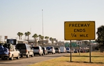 Thousands of motorists wait in line on the southernmost stretch of IH-35 in Laredo, Texas. Despite a global recession and escalating violence in Mexico thousands of "paisanos" still made the trek south for Christmas. As the hours passed, however, their concerns about traveling Mexico's highways at night grew. A recent prison break in Nuevo Laredo didn't help soothe their fears about bandits lurking on the roadways. "We might have to get a hotel here," said one traveler.
