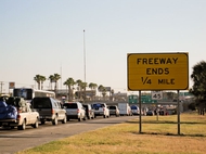 Thousands of motorists wait in line on the southernmost stretch of IH-35 in Laredo, Texas. Despite a global recession and escalating violence in Mexico thousands of "paisanos" still made the trek south for Christmas. As the hours passed, however, their concerns about traveling Mexico's highways at night grew. A recent prison break in Nuevo Laredo didn't help soothe their fears about bandits lurking on the roadways. "We might have to get a hotel here," said one traveler.
