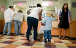 Patients check out at the People's Community Clinic in Austin, a safety-net clinic that serves Medicaid recipients and the under-insured. The federal government is preparing to reduce the percentage of Texas Medicaid expenses that it currently pays, adding to the state's fiscal problems. 
