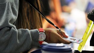 Students scan their radio frequency identification tags as they pass through the lunch line at Jones Middle School in San Antonio, September 14, 2012.