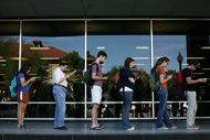 Voters wait in line to cast their ballots at the Flawn Academic Center on the University of Texas at Austin campus on Tuesday, Nov. 6, 2012 in Austin, Texas.