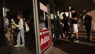 Voters wait in line to cast their ballots at a polling station in the Hancock Center on Tuesday Nov. 6, 2012 in Austin, Texas.