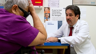 Dr. Javier Saenz with a patient, Elena Chavez, 73. Chavez is part of the 50 percent of patients Saenz sees who draw from both Medicare and Medicaid.