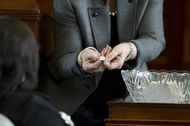 Sen. Leticia Van de Putte, D-San Antonio, is shown her lottery number by Senate Secretary Patsy Spaw on Jan. 23, 2013.