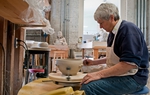 Jan Ahart sands down a ceramic bowl at the Bosque Arts Center in Clifton.